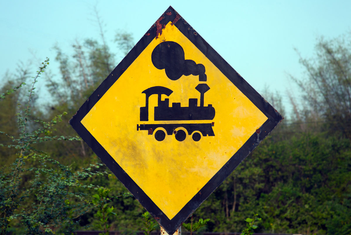 Antique steam train icon and caution sign, at Wang Duan, narrowest part of peninsula Thailand (10.96 km) . Copyright John Borthwick